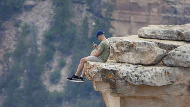 Dangling feet off cliff at the Grand Canyon, Idiot 1 poster