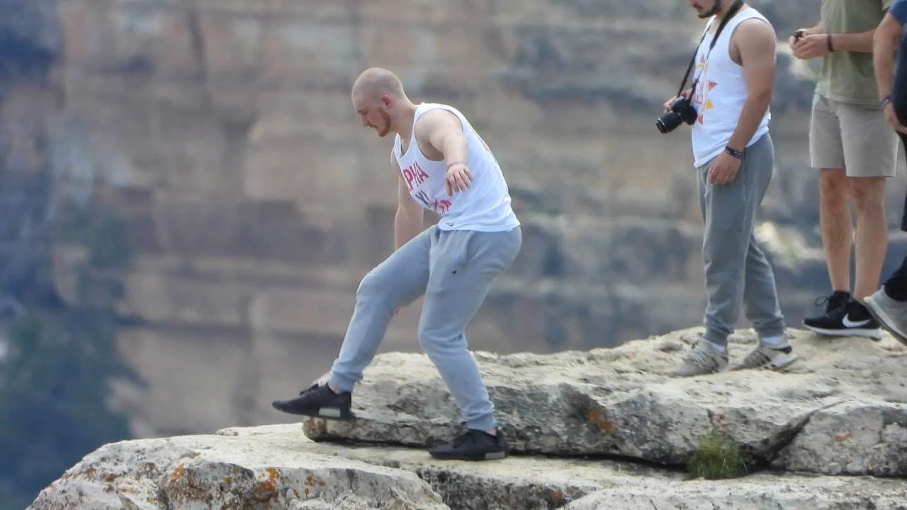 Dangling feet off cliff at the Grand Canyon, Idiot 3