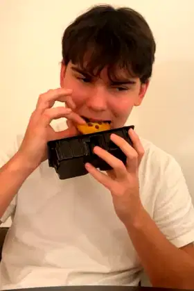 a chinese man eats a biscuit poster